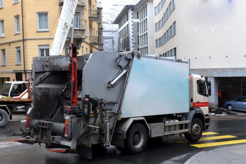 Low-emission waste collection van parked at a transfer station